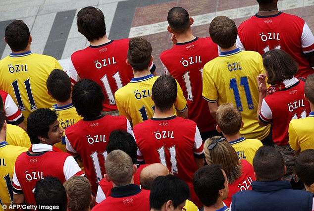 1407768344097 wps 2 Arsenal fans wearing the 