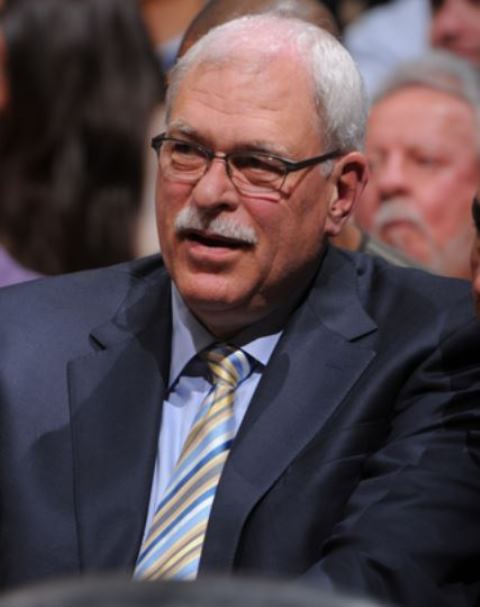 Phil Jackson with mustache looks on wearing sunglasses at Staples Center 2013